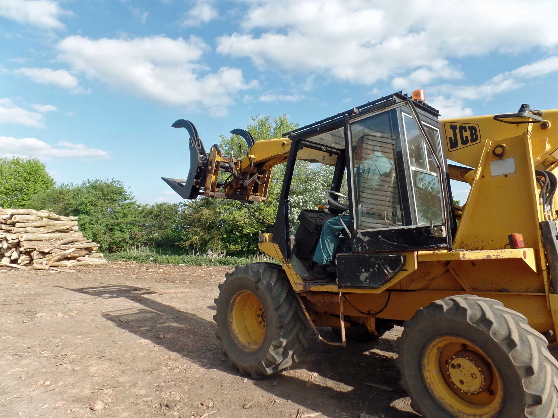 JCB Forklift approaching log pile HD